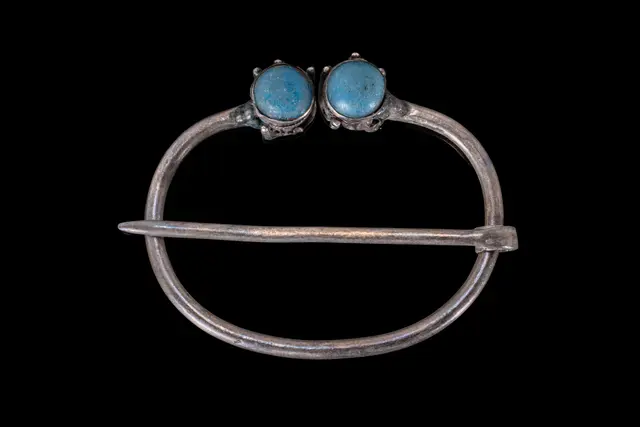 VIKING SILVER PENANNULAR BROOCH WITH TWO TURQUOISE CABOCHONS