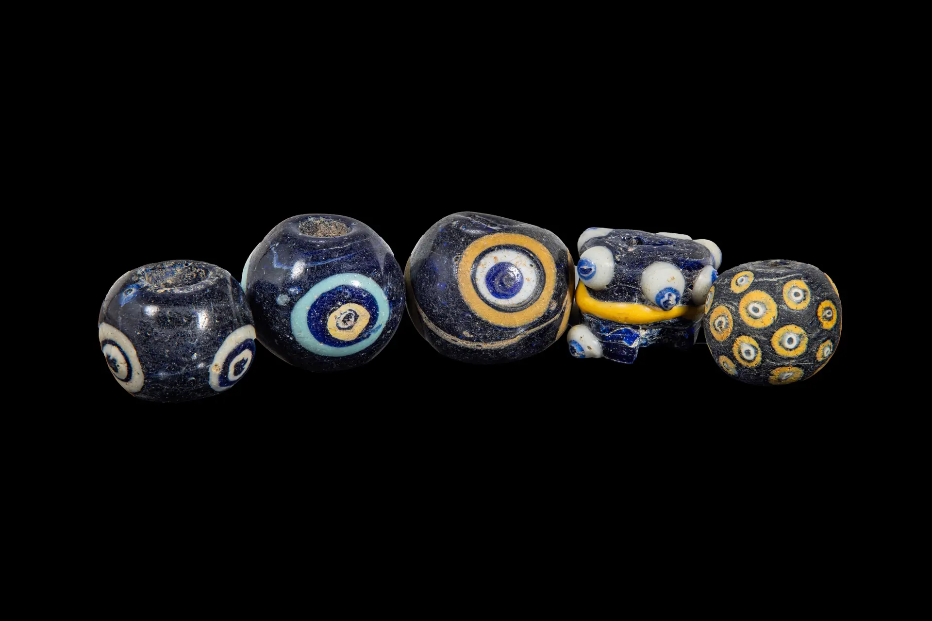 COLLECTION OF LARGE PHOENICIAN POLYCHROME GLASS EYE BEADS