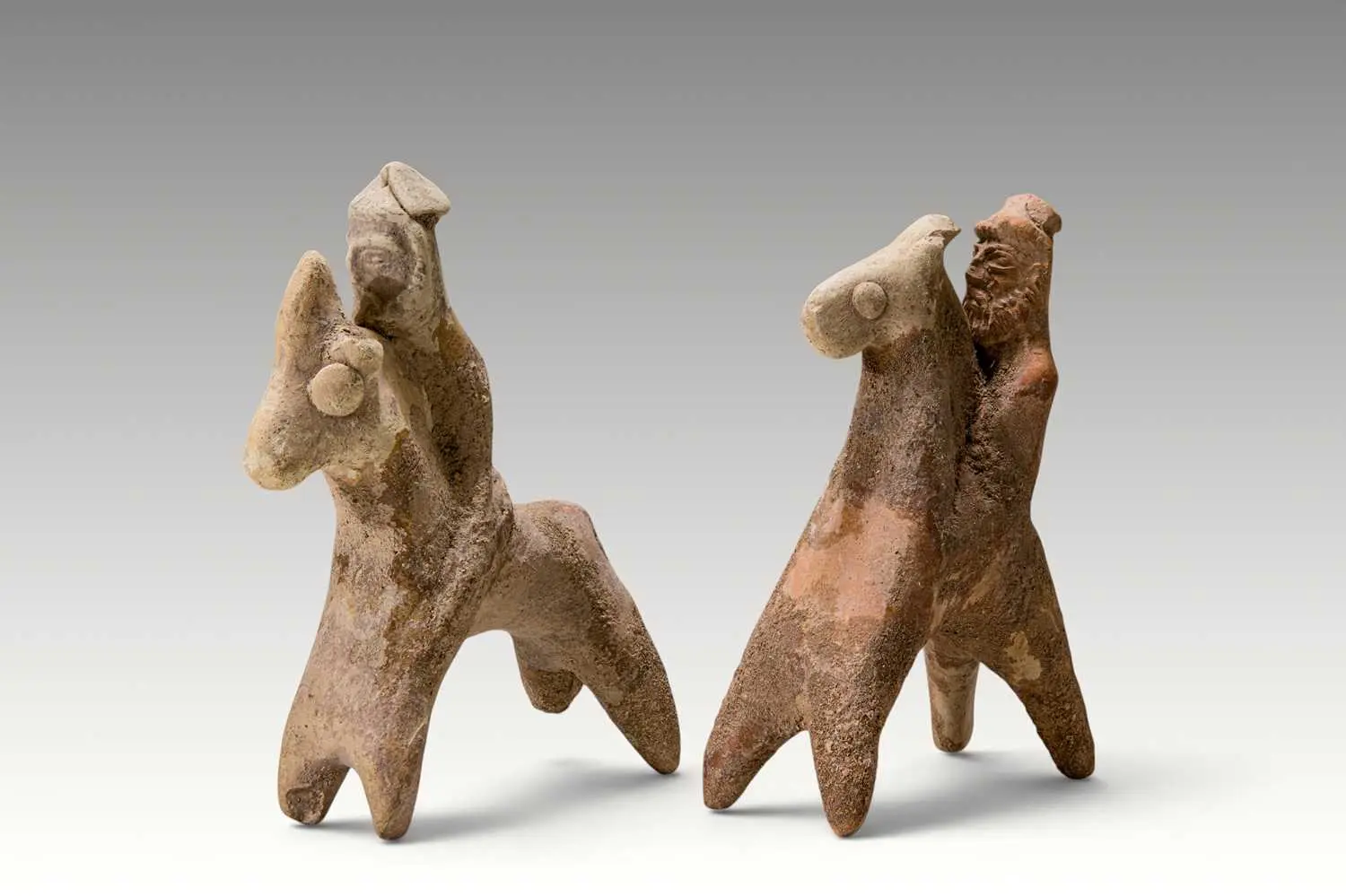 PAIR OF CYPRIOT TERRACOTTA HORSE-AND-RIDER FIGURES