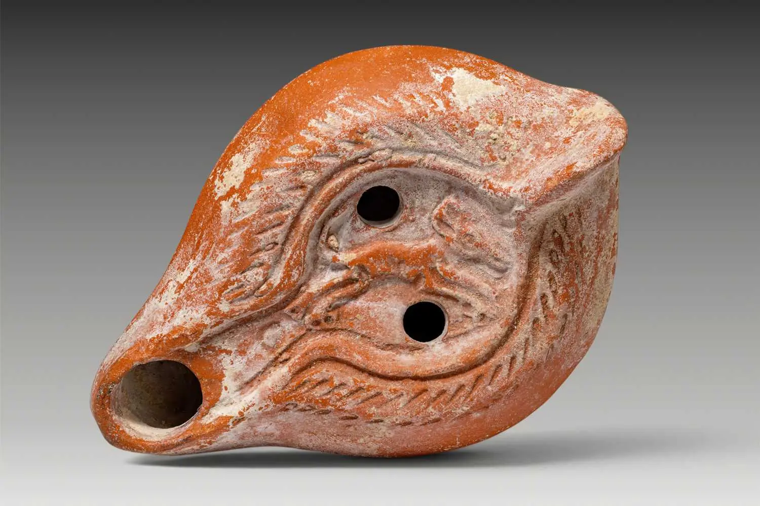 BYZANTINE TERRACOTTA OIL LAMP WITH LEAPING HOUND AND CHI-RHO