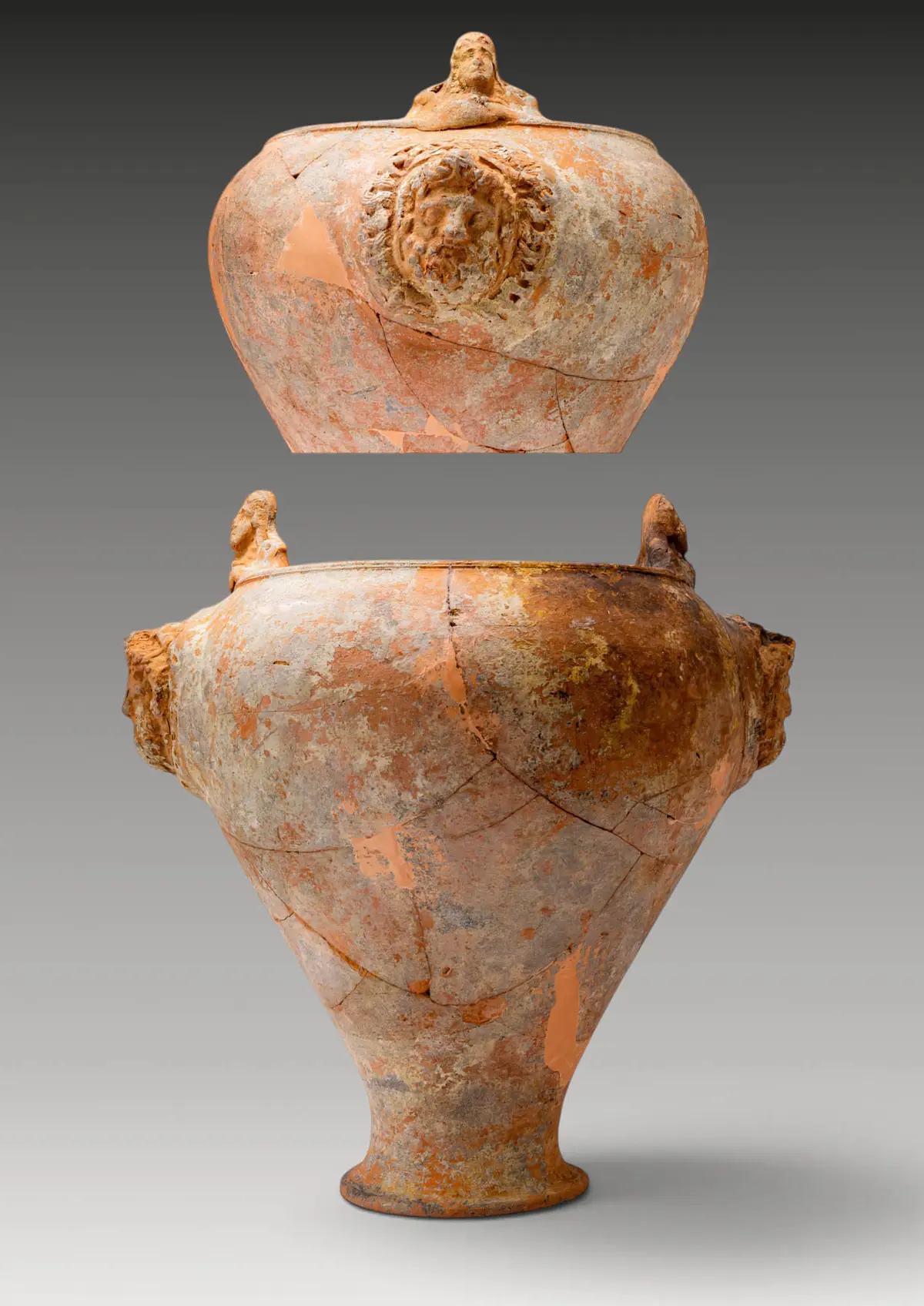 GREEK TERRACOTTA SITULA WITH APPLIED HEADS OF DEITIES
