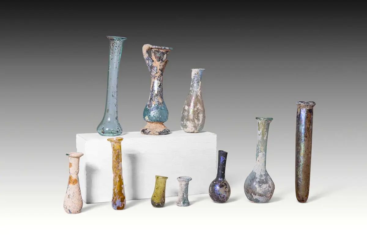 LARGE COLLECTION OF TEN ROMAN GLASS UNGUENTARIA