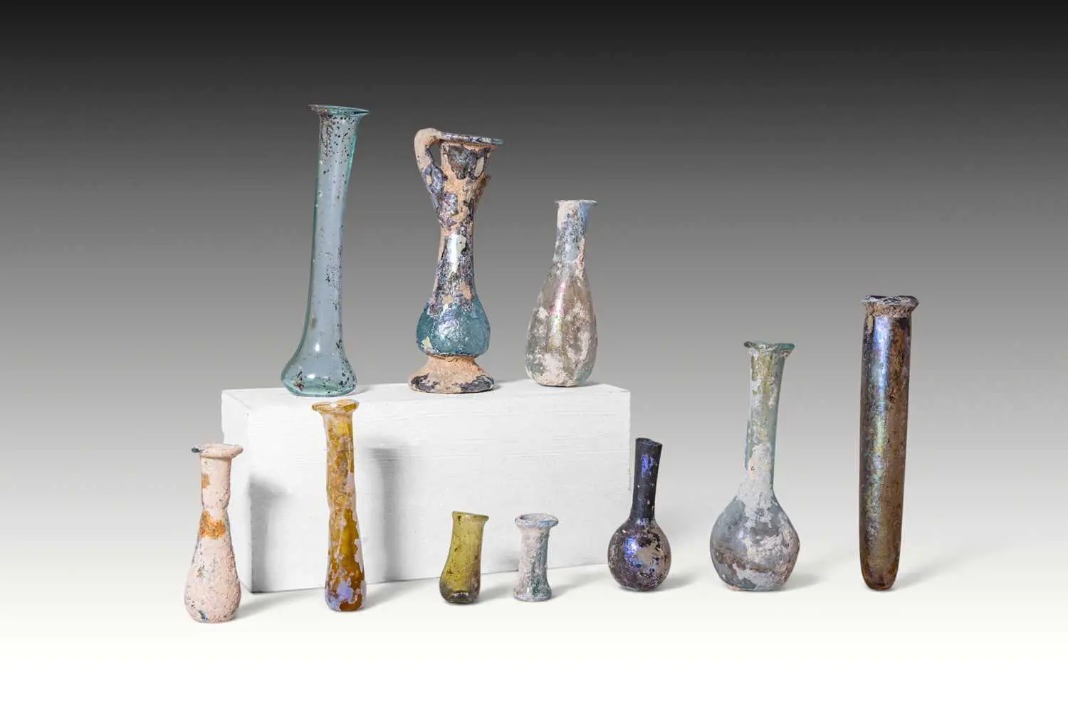 LARGE COLLECTION OF TEN ROMAN GLASS UNGUENTARIA