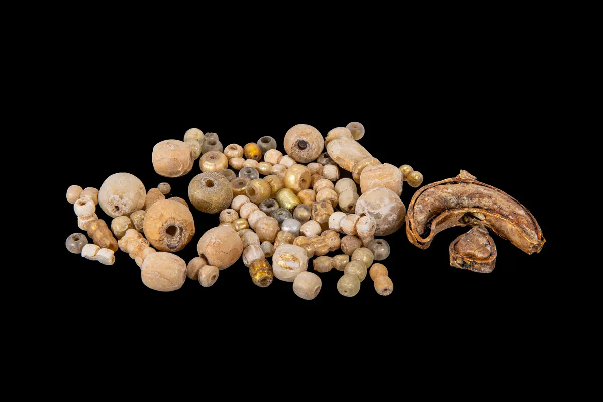LARGE COLLECTION OF VIKING GOLD LEAF GLASS BEADS AND LUNULA PENDANT