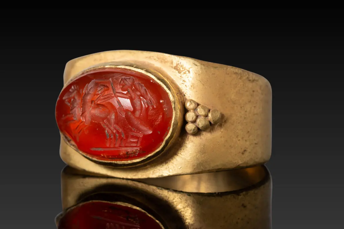 ROMAN CARNELIAN INTAGLIO DEPICTING CUPID DRIVING A TWO-HORSE CHARIOT