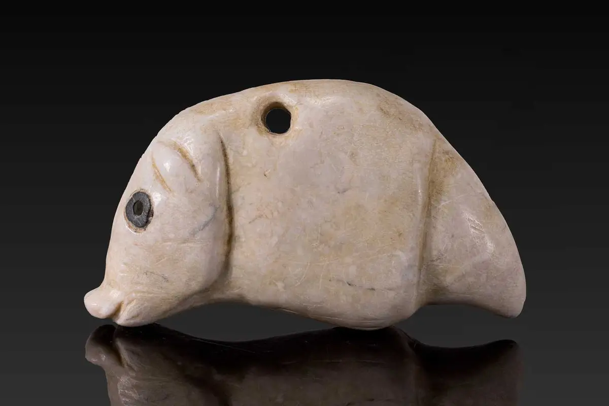 JEMDET NASR STONE AMULET IN THE FORM OF A HOG