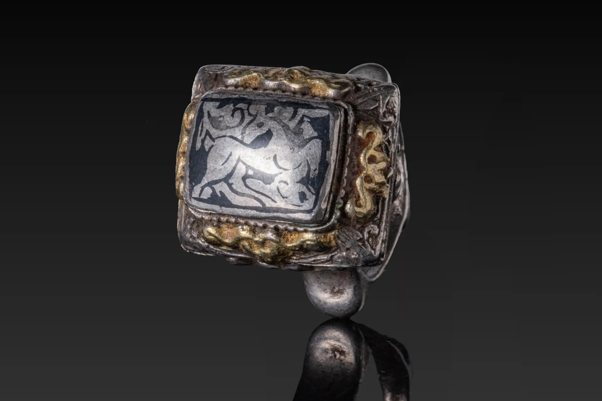 SELJUK SILVER AND NIELLO RING WITH DEER AND FLORAL MOTIF