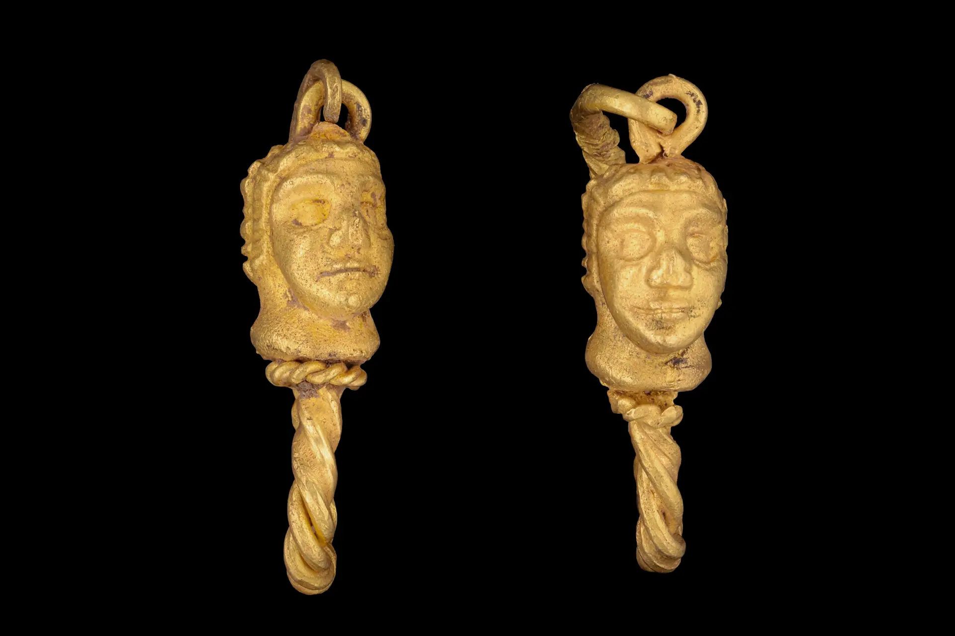 MATCHED PAIR OF HELLENISTIC GOLD EARRINGS WITH MALE HEADS