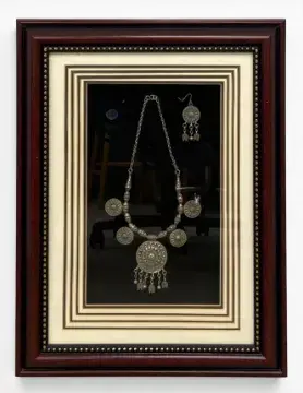 A vintage tribal style white metal necklace and earring set in a glazed