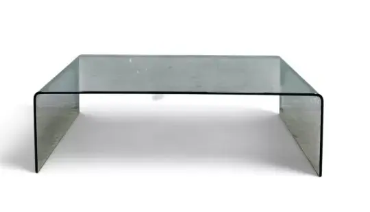 A contemporary bent plate glass coffee table. H.32 x W.108 x D.60cm.
