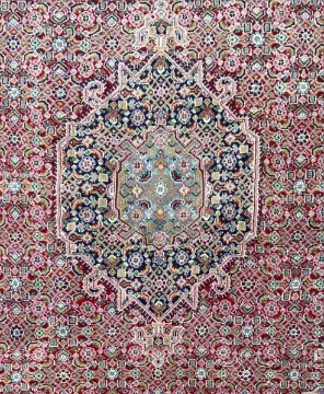 A Kazak carpet with a central lozenge medallion on a burgundy field