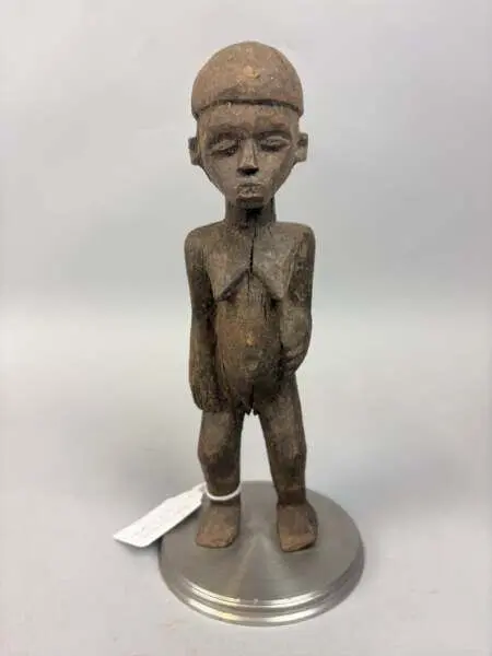 Carved wooden female figurine with a brown patina, depicted - Lot 237