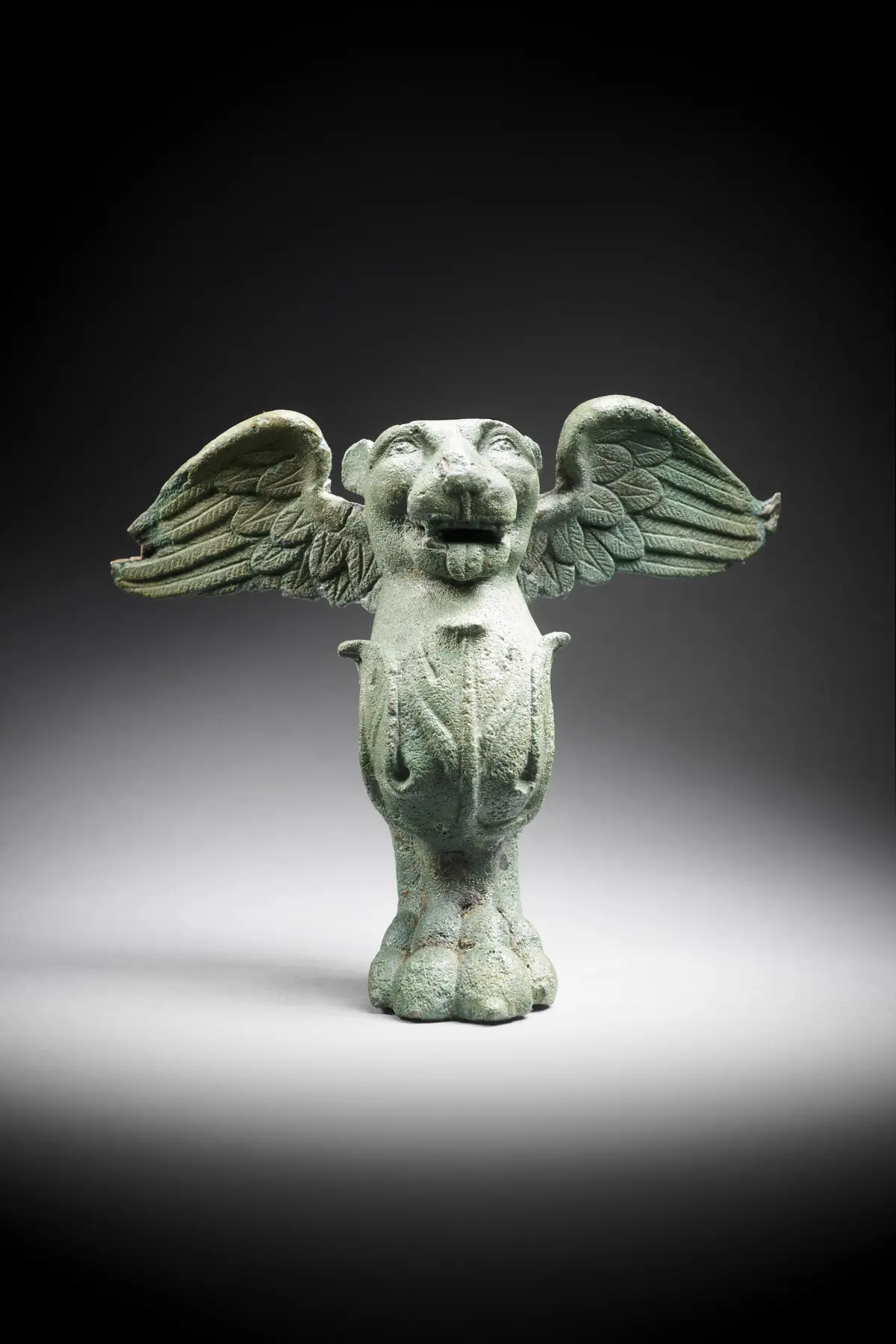 A Parthian bronze cista or furniture foot in the shape of a winged lion