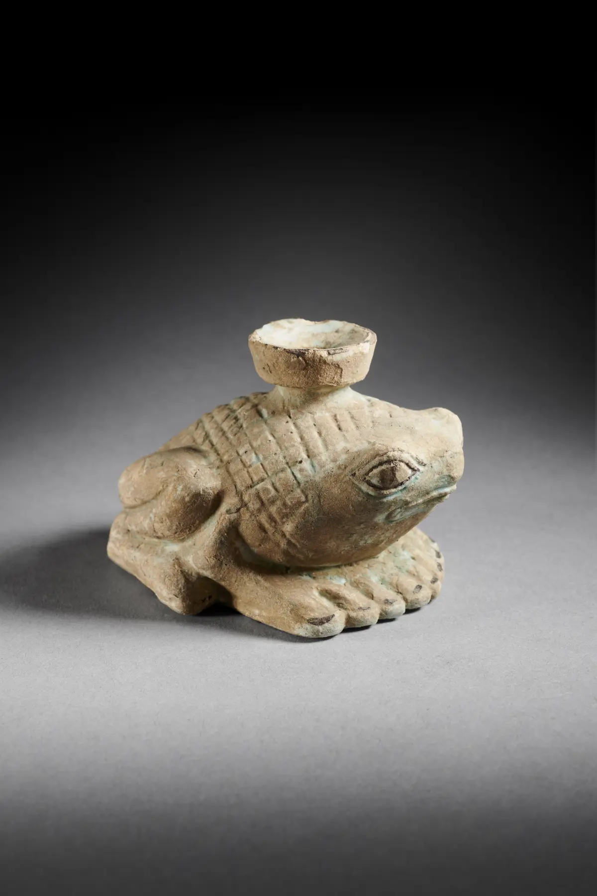 A Greek faience frog-shaped aryballos