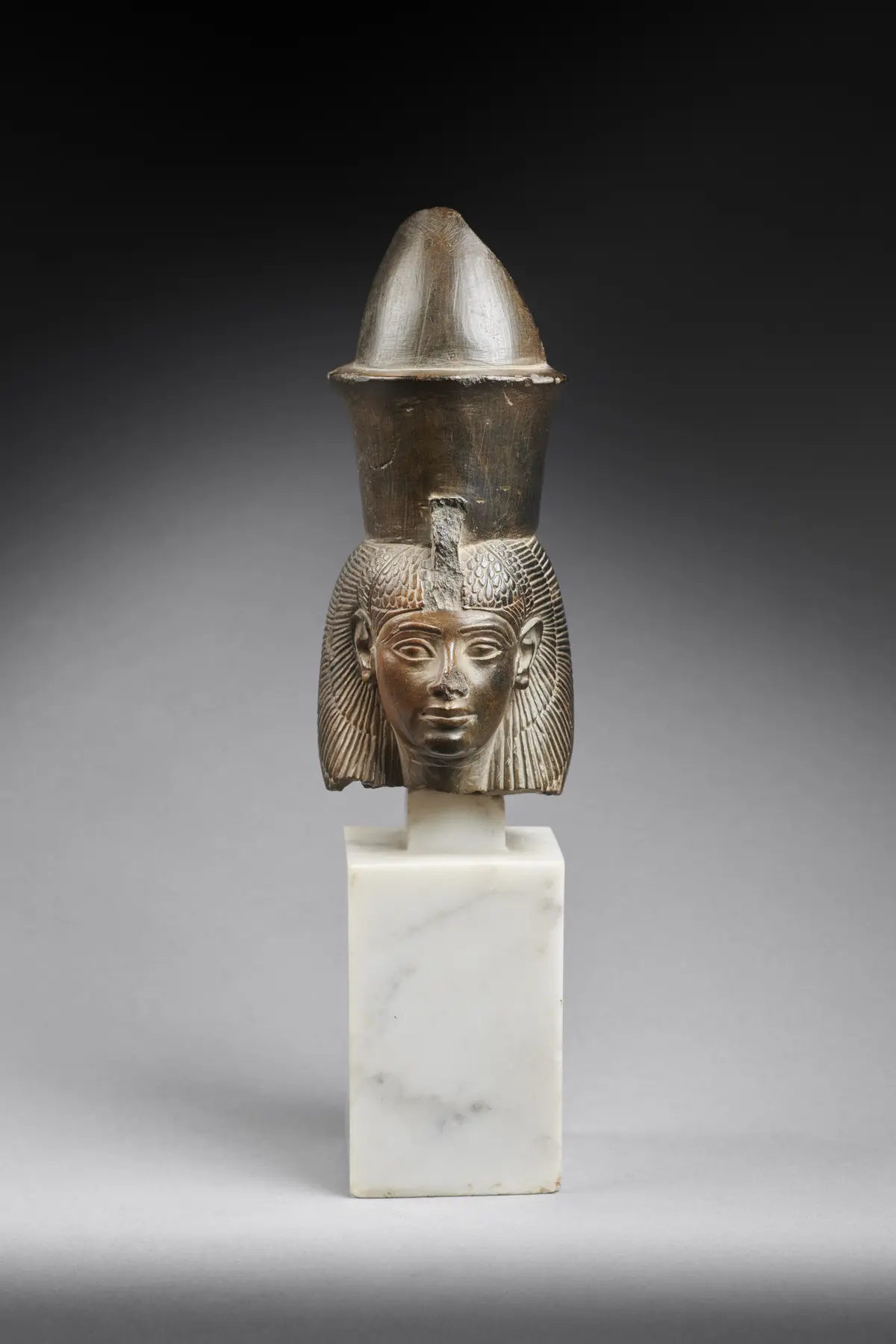 An Egyptian greywacke head of the goddess Mut