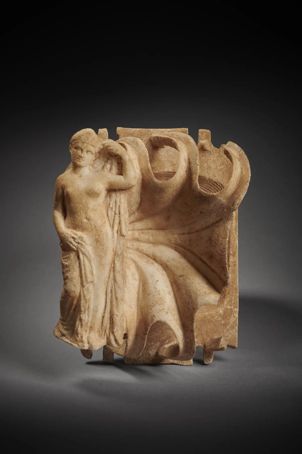A Roman marble palette with female figure