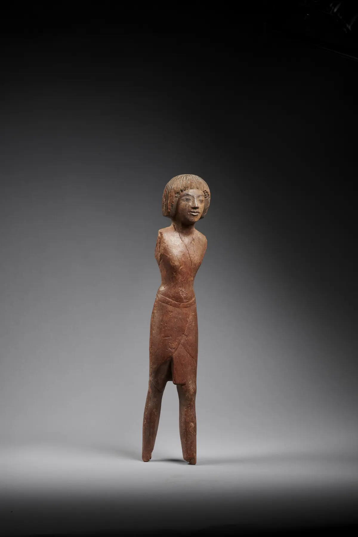 An Egyptian wood figure of a man