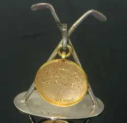 A 9ct gold golfing medal,, the obverse cast with a golfer in swing and a caddie, reverse engraved 'First Class, J. Stacey' , ring suspension,...