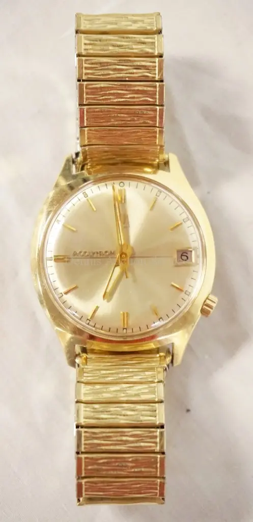 14K GOLD BULOVA ACCUTRON WRIST WATCH WITH A 10K GOLD FILLED BAND.