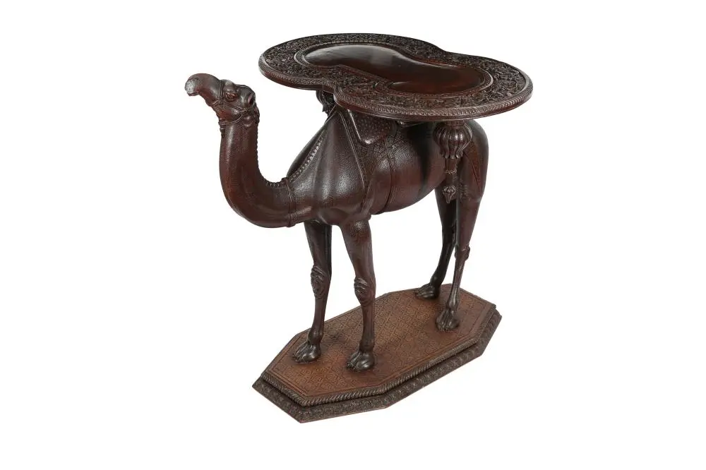 AN ANGLO-INDIAN CARVED HARDWOOD OCCASIONAL CAMEL TABLE